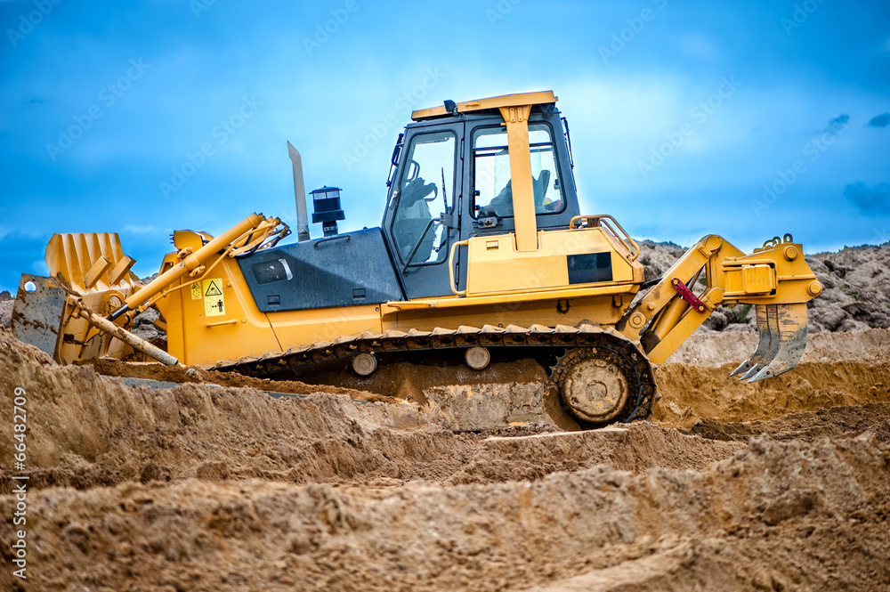 bulldozer or excavator working with soil on construction site bulldozer or excavator working with soil on construction site