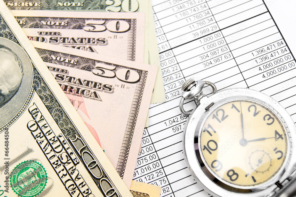 Watch and money on documents. Watch and money on documents.
