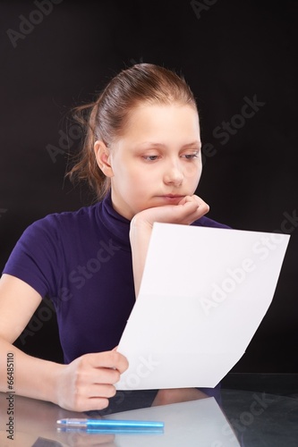 Teen girl reading letter