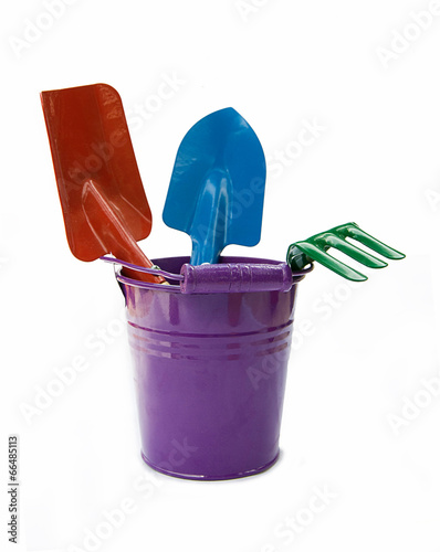 garden bucket with gardening tools isolated on white