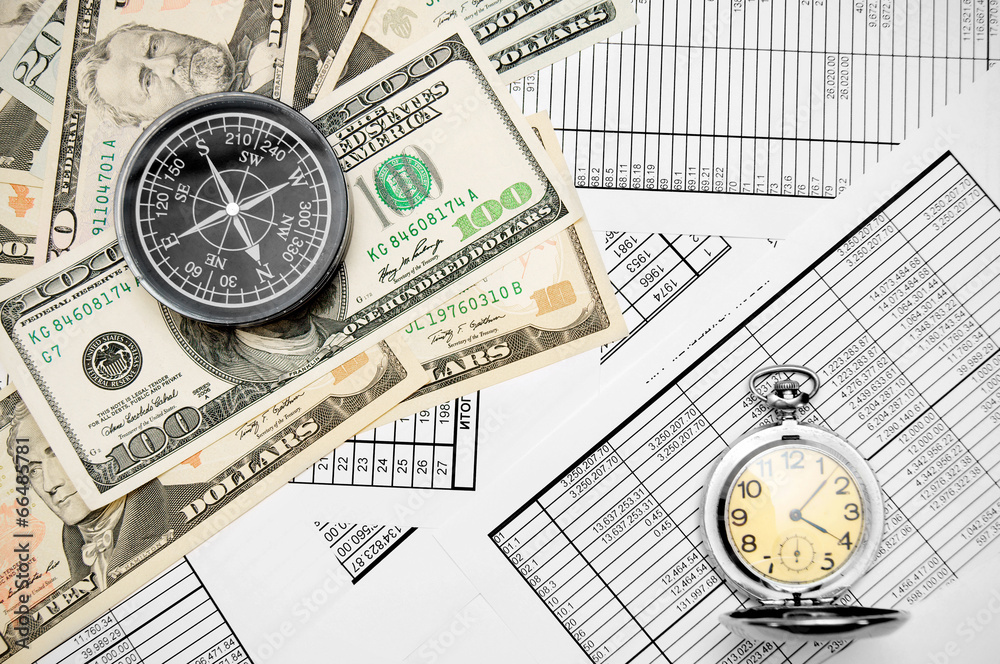 Compass , watch and money (dollars). On documents. Compass , watch and money (dollars). On documents.
