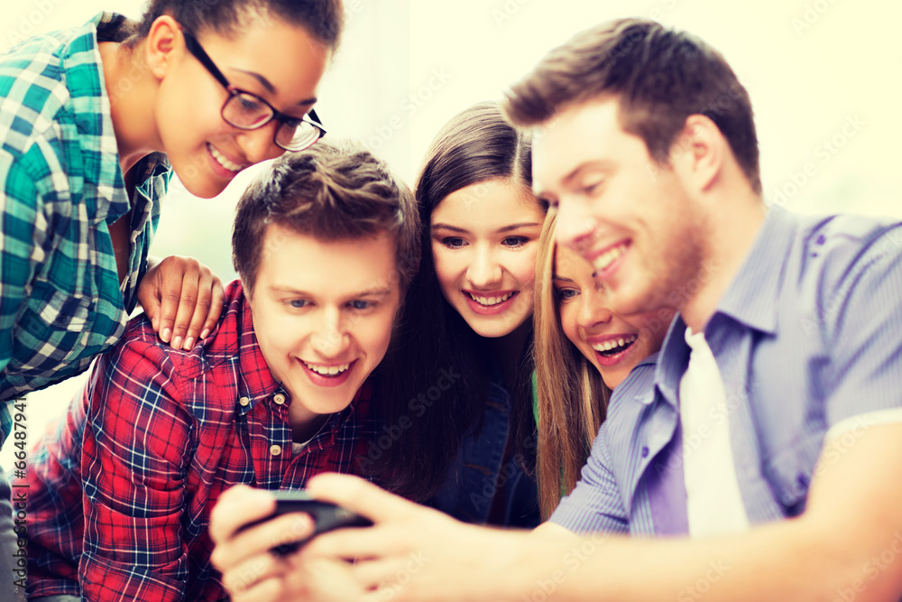 Fototapeta premium students looking at smartphone at school