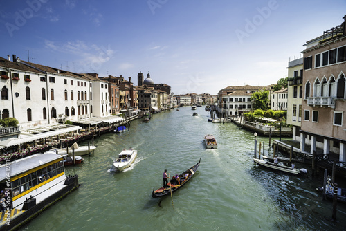 Ancient buildings and boats in the channel in Venice