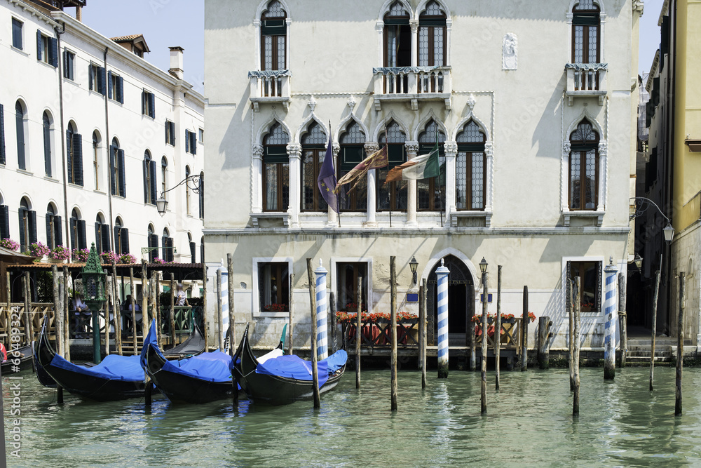 Ancient buildings and boats in the channel in Venice