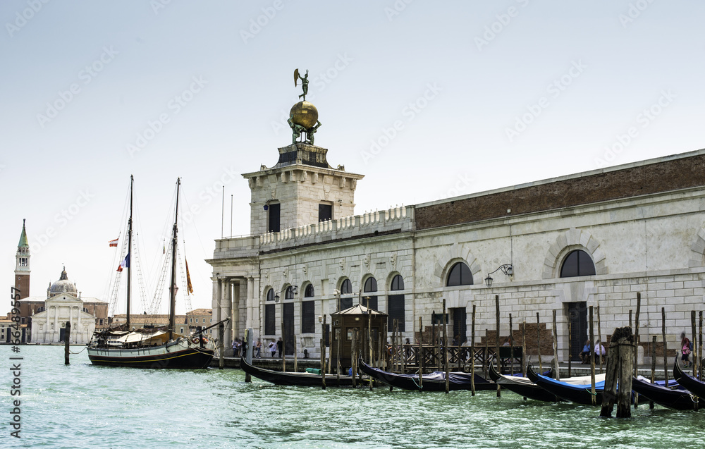 Ancient buildings and boats in the channel in Venice