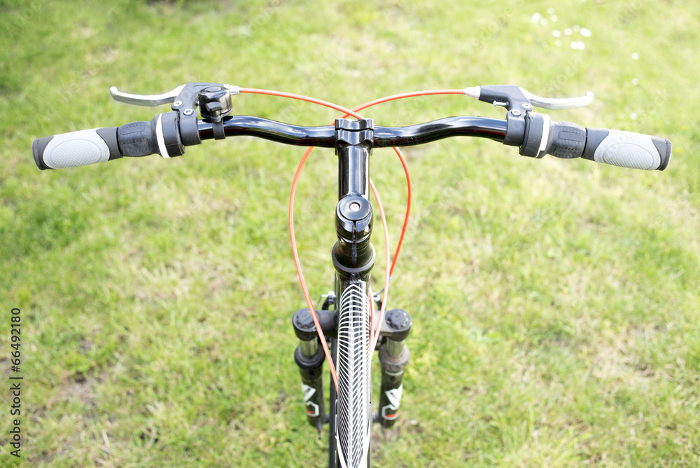 Black mountain bike on a green grass Black mountain bike on a green grass
