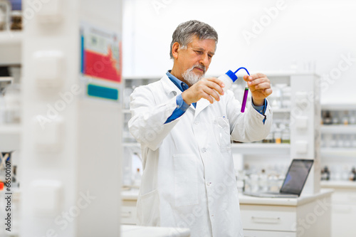 Wallpaper Mural Senior male researcher carrying out scientific research in a lab Torontodigital.ca