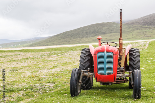 Vintage red tractor in a field in UK photo