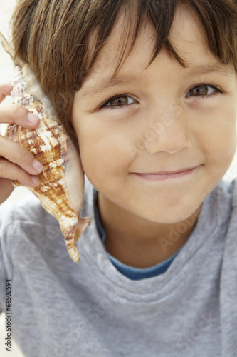 Young boy with seashell