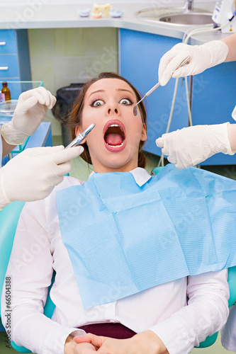 Patient in dentist office scared, afraid of doctor, procedure photo