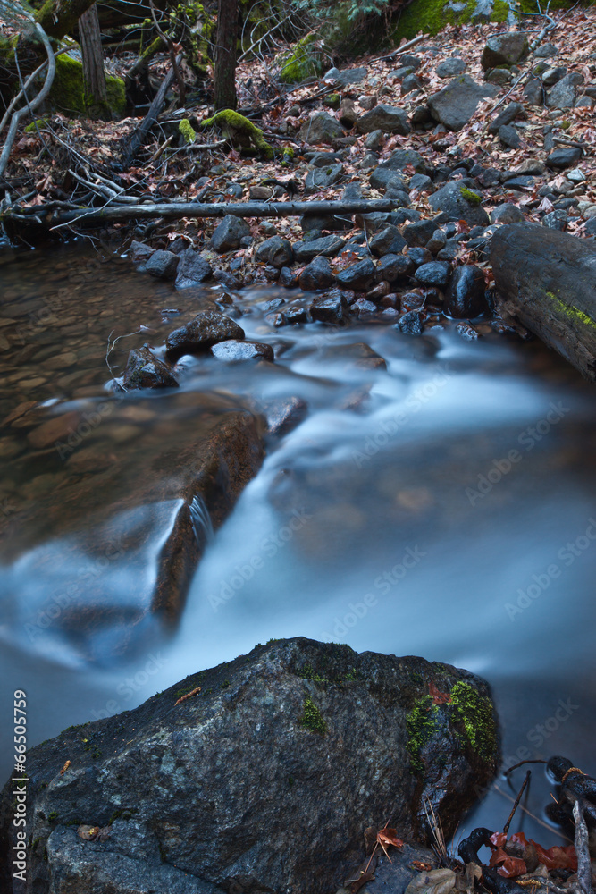 Soft flowing water over granite rocks Soft flowing water over granite rocks