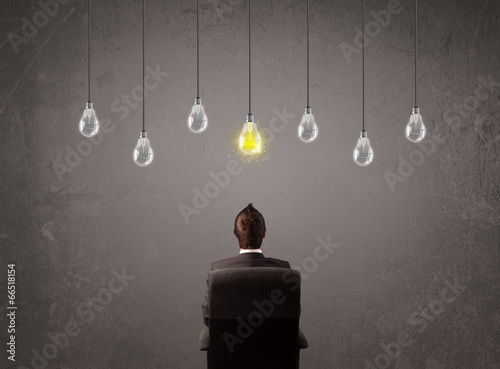 Businness guy in front of idea light bulbs concept photo