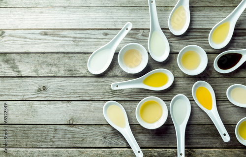 Topview of soup spoons and sauce dishes with oil photo