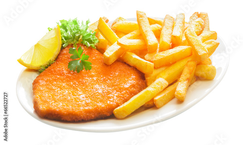 Fried crumbed veal escalope with French fries photo