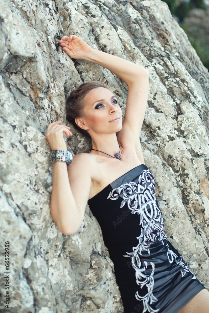 Beautiful young woman posing on a road over picturesque Beautiful young woman posing on a road over picturesque
