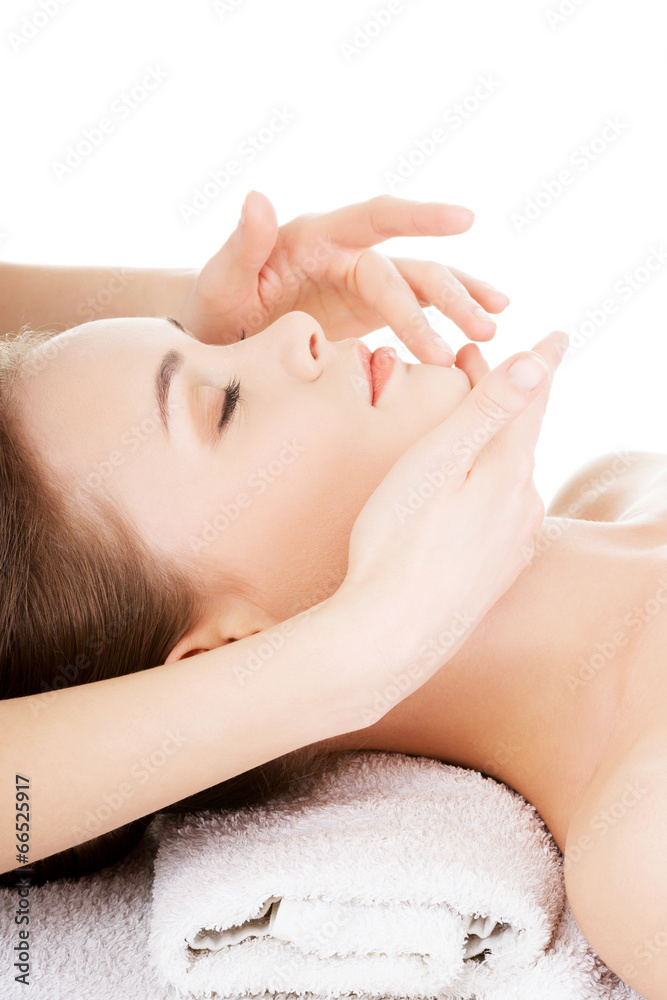 Relaxed woman enjoy receiving face massage Relaxed woman enjoy receiving face massage