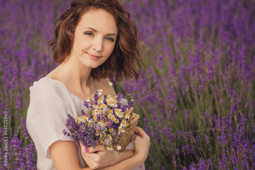 Smiling beautiful brunette in the lavender field Smiling beautiful brunette in the lavender field