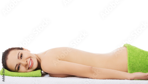 Woman lying at spa salon.