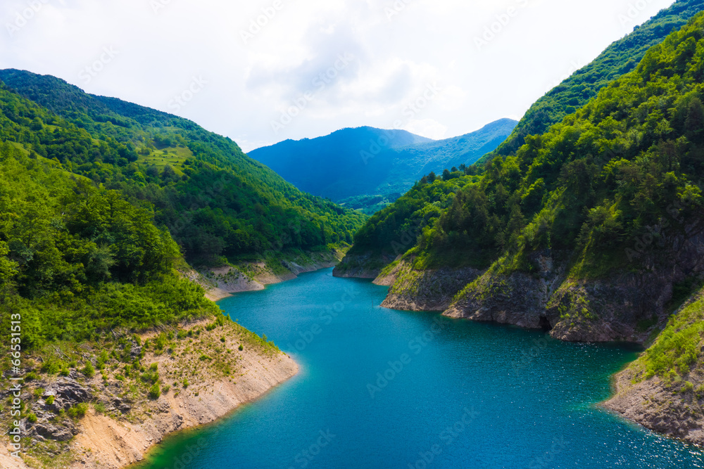 Mountain lake. Beautiful landscape with lake, forest and mounta Mountain lake. Beautiful landscape with lake, forest and mounta