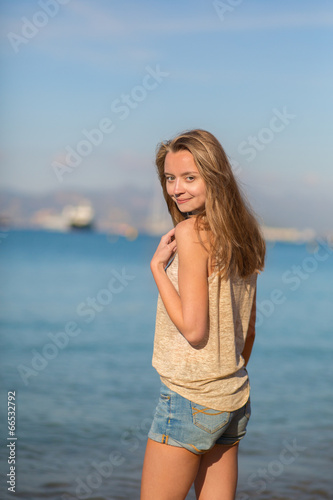 Beautiful young woman at the beach