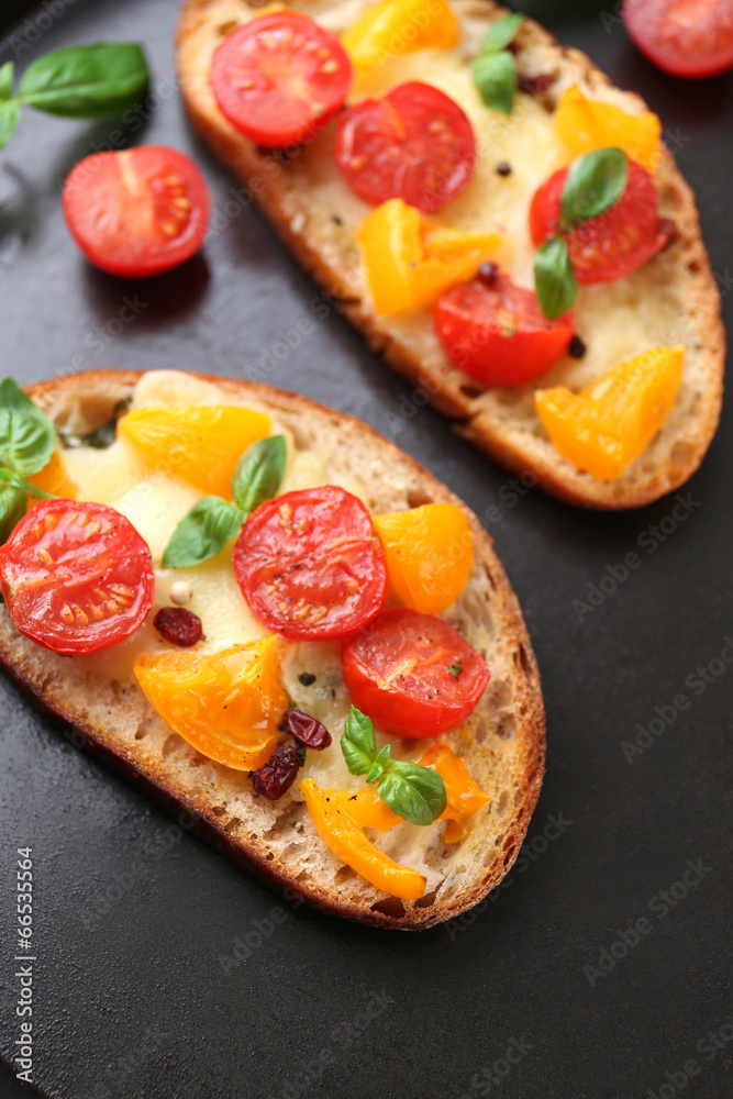 Tasty bruschetta with tomatoes in pan, close up Tasty bruschetta with tomatoes in pan, close up