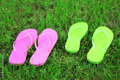Bright flip-flops on green grass