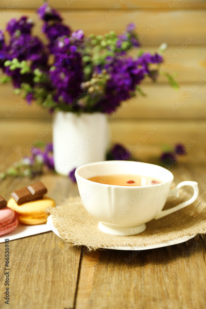 Cup of fresh herbal tea on wooden table Cup of fresh herbal tea on wooden table