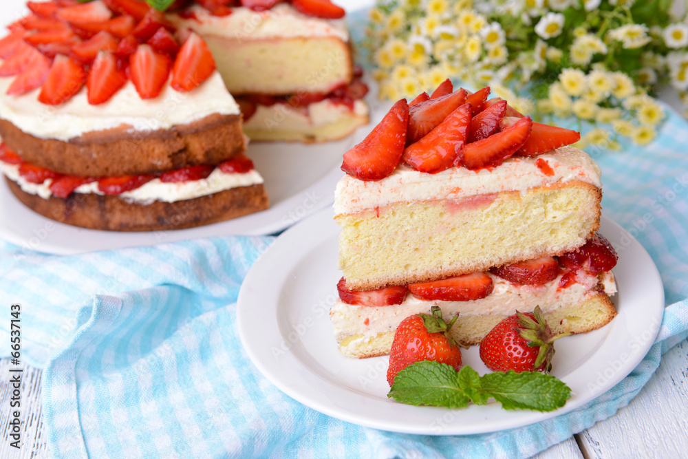 Delicious biscuit cake with strawberries on table close-up Delicious biscuit cake with strawberries on table close-up