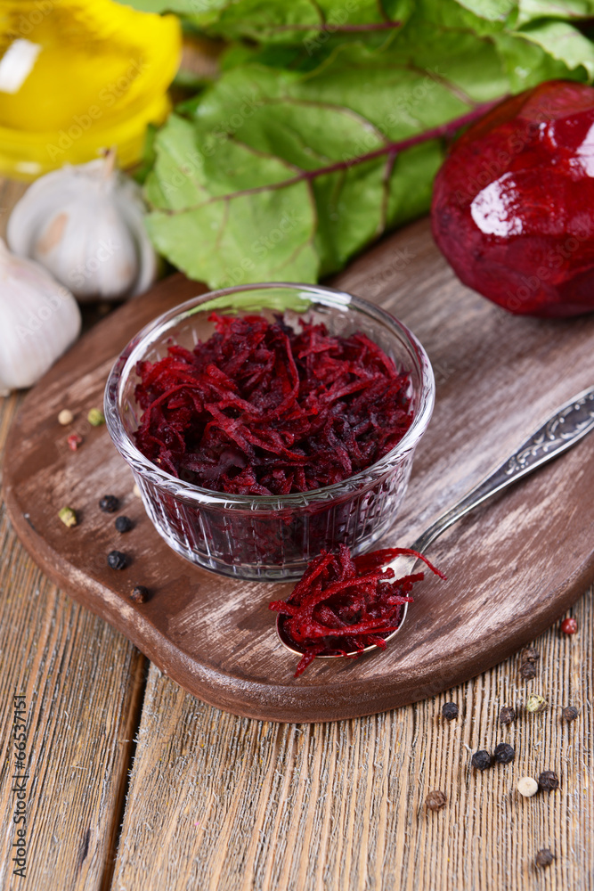 Grated beetroots in bowl on table close-up Grated beetroots in bowl on table close-up