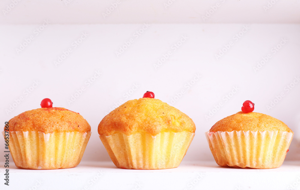 Tasty muffins on wooden shelves, close-up Tasty muffins on wooden shelves, close-up