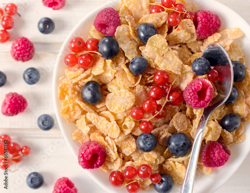 Cereal with berry fruit in the bowl from above