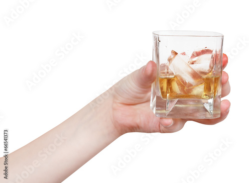 hand holds glass with whiskey isolated