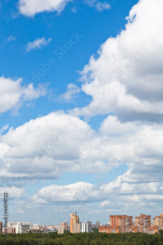 woolpack clouds over urban district photo