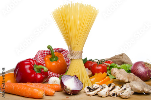 Composition of uncooked spaghetti and different types of vegetab
