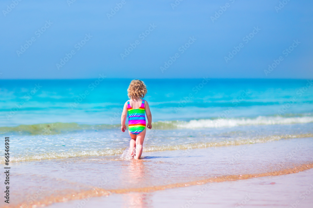 Little girl running on a beach Little girl running on a beach