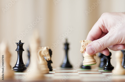 Chess pieces set on a chessboard photo