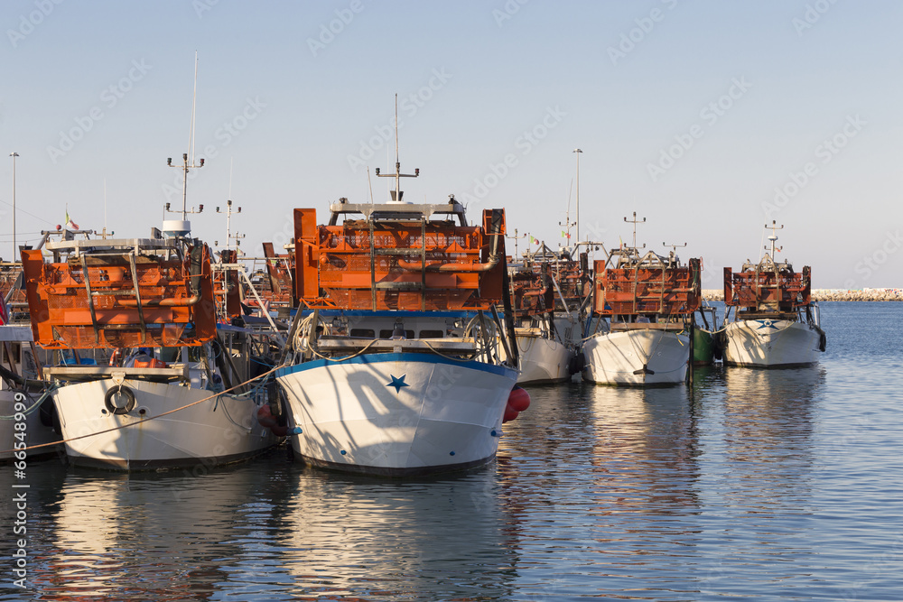 fishing boats in harbor - machine to collect the clams
