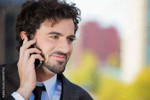 Businessman talking on a phone outside outdoor background 