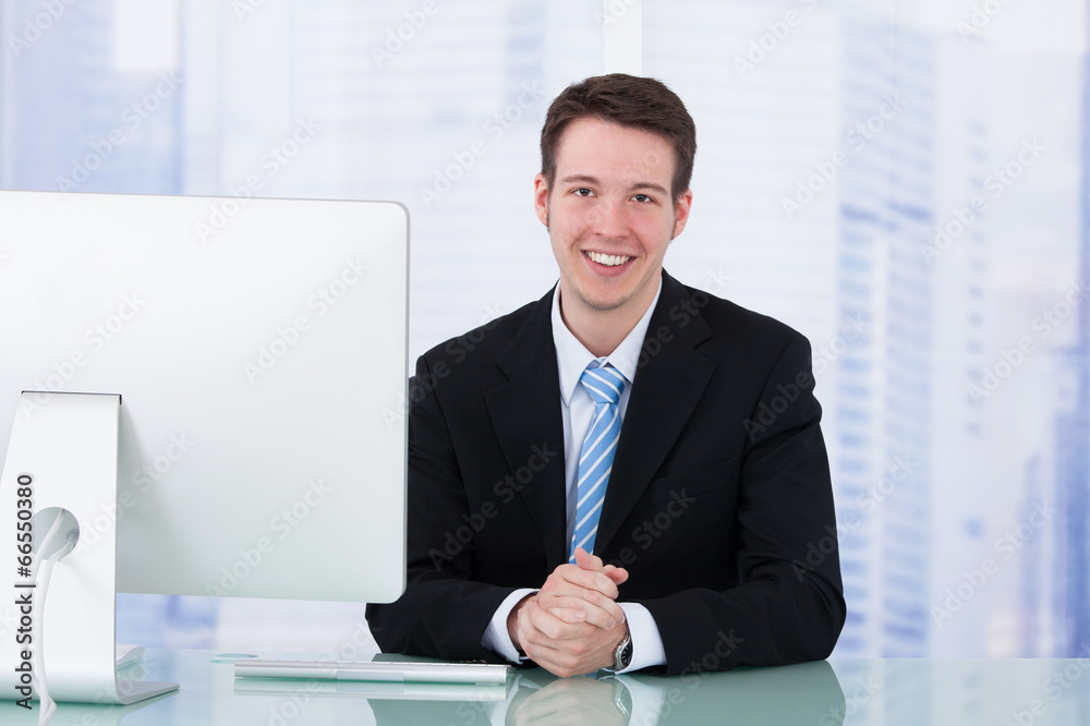 Businessman Using Computer At Office Desk Businessman Using Computer At Office Desk