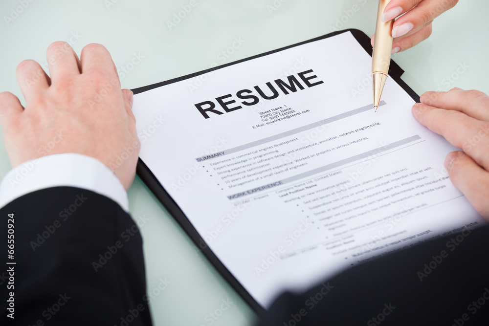 Businessman With Resume At Desk Businessman With Resume At Desk