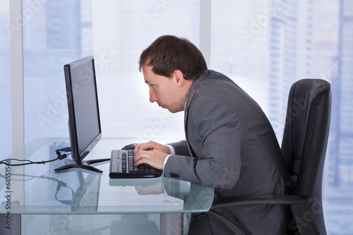 Concentrated Businessman Working On Computer In Office