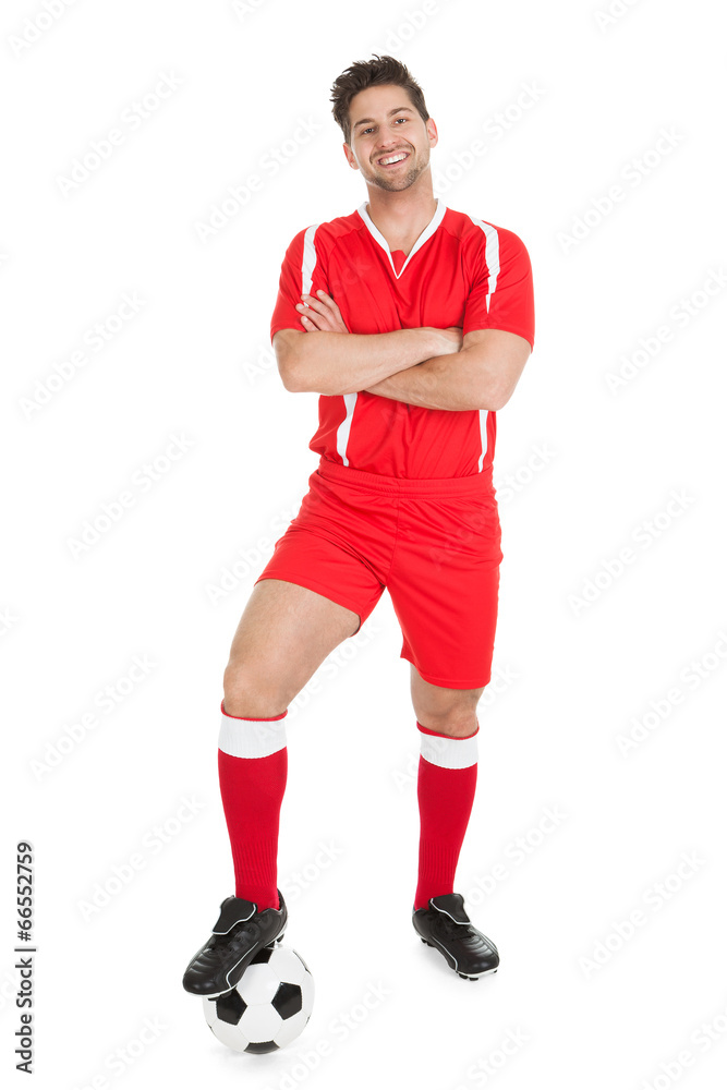 Confident Player With Leg On Soccer Ball