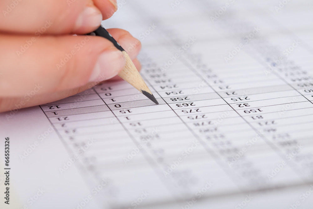 Businesswoman Writing On Financial Paper Businesswoman Writing On Financial Paper