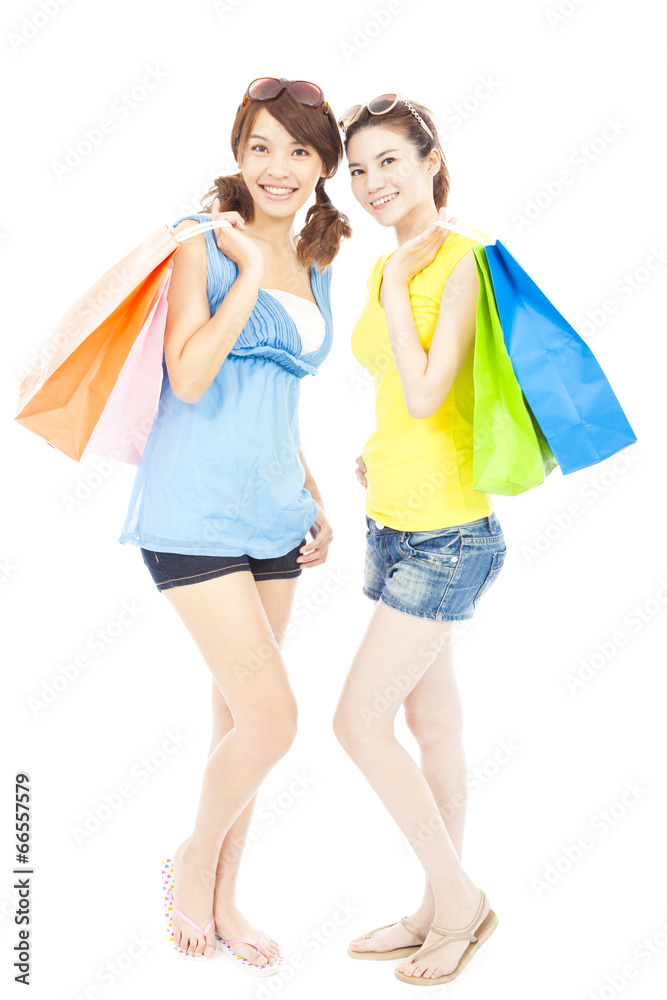 happy pretty young sisters holding shopping bags happy pretty young sisters holding shopping bags