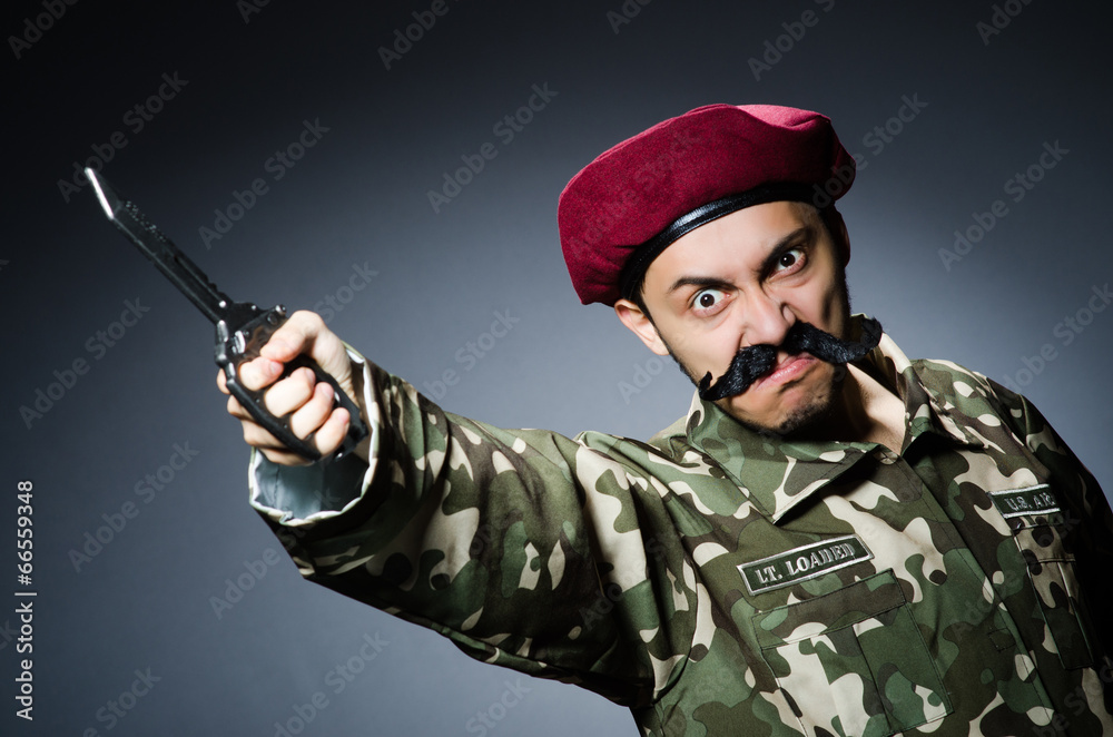 Funny soldier against the dark background Funny soldier against the dark background