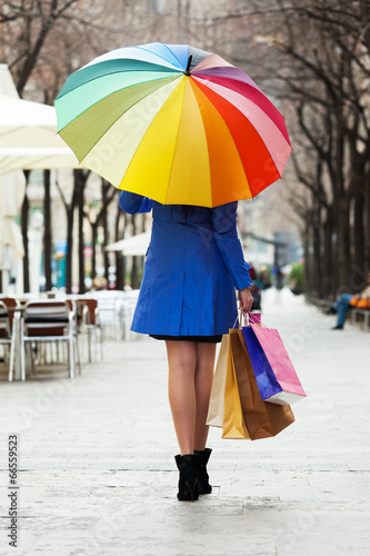  woman with purchases and umbrella