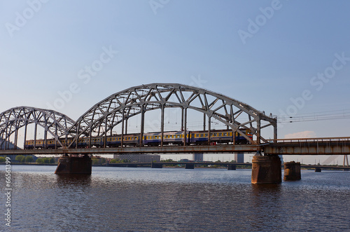 Train on the bridge over Daugava River. Riga, Latvia © joymsk