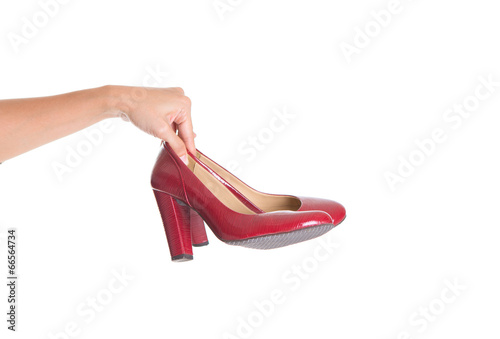 Female hand holding high heels over white background