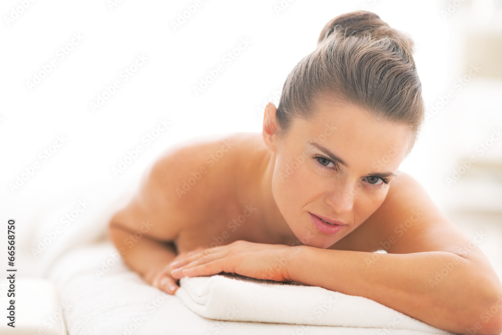Young woman laying on massage table Young woman laying on massage table