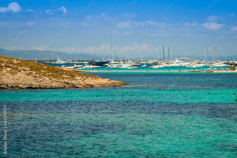 Luxury yachts in turquoise beach of Formentera Illetes